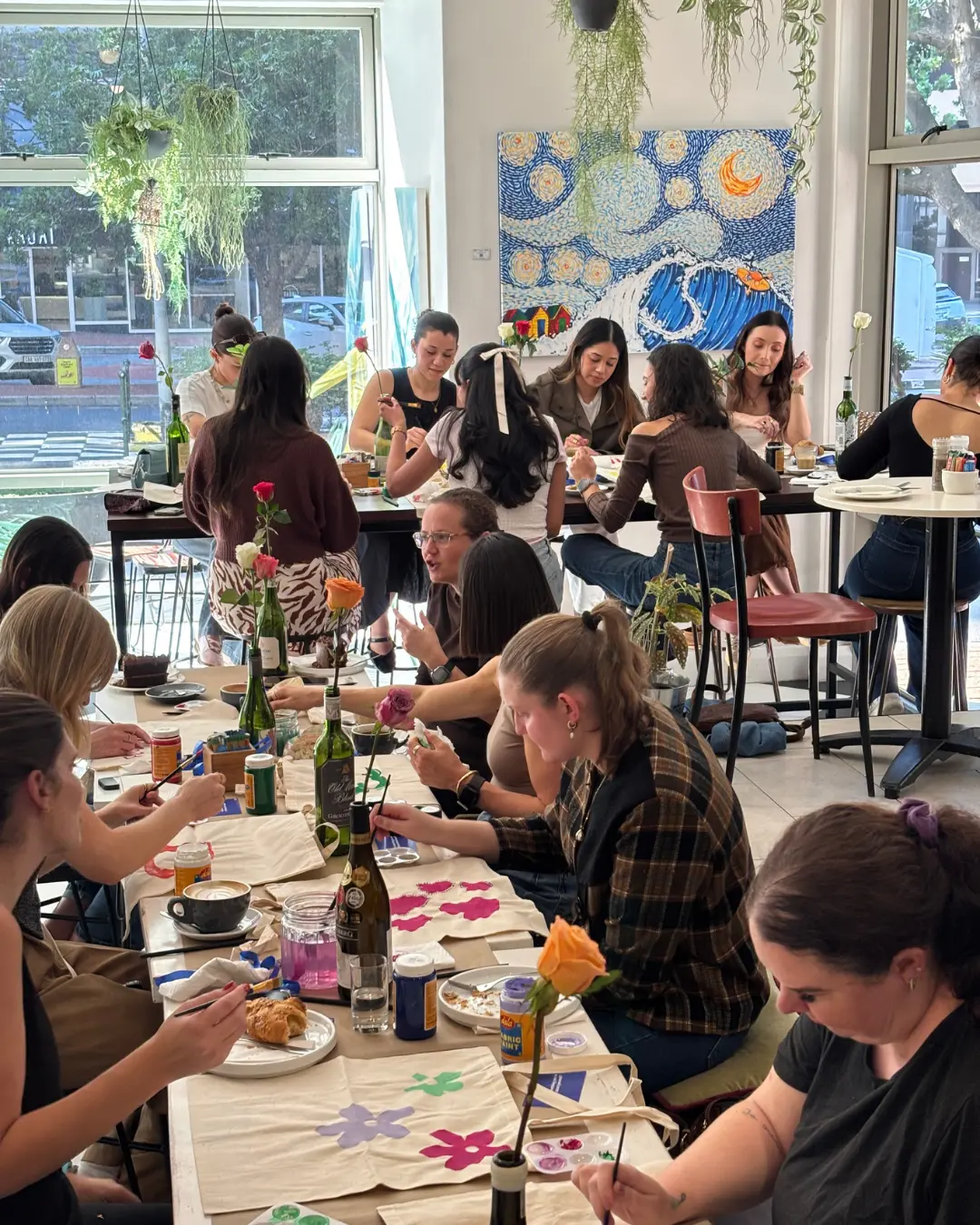 Women painting tote bags at a Full Circle paint and sip